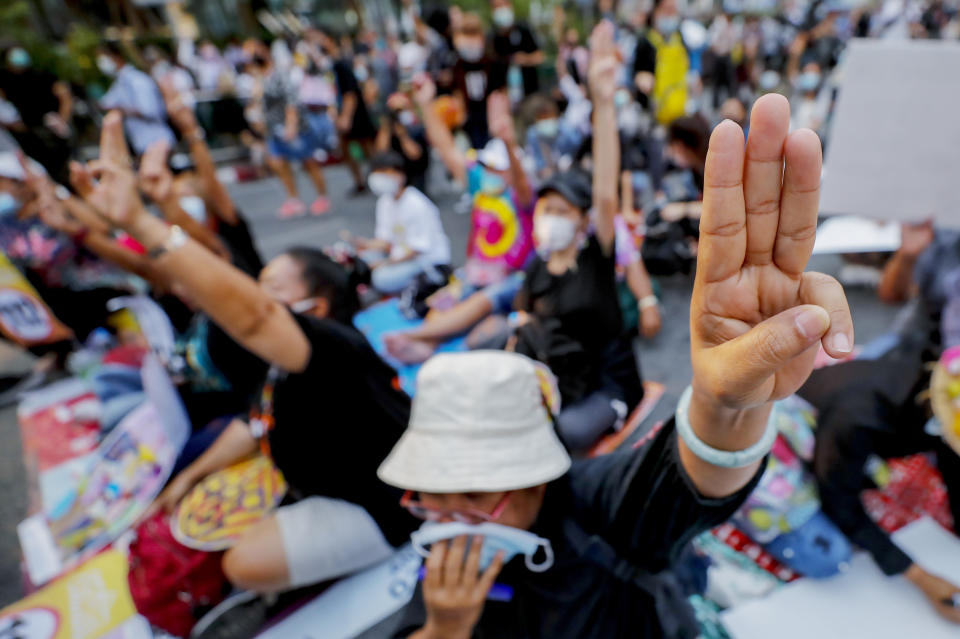 FILE - Pro-democracy activists flash a three-fingered symbol or resistance during a rally in Bangkok, Thailand, on March 24, 2021. Cybersecurity researchers have found that Thai activists involved in the country’s pro-democracy protests had their cell phones or other devices infected and attacked with spyware. (AP Photo/Sakchai Lalit, File)