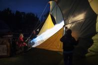 A hot air balloon pilot fires up his craft for a night glow on the evening of Day 3 of the Canadian Hot Air Balloon Championships in High River September 27, 2013. Spectators had the opportunity to walk among the balloons which do not actually launch. The launches during the day will determine qualifiers for the World Hot Air Balloon Championships in Sao Paulo in 2014. REUTERS/Mike Sturk (CANADA - Tags: SOCIETY)