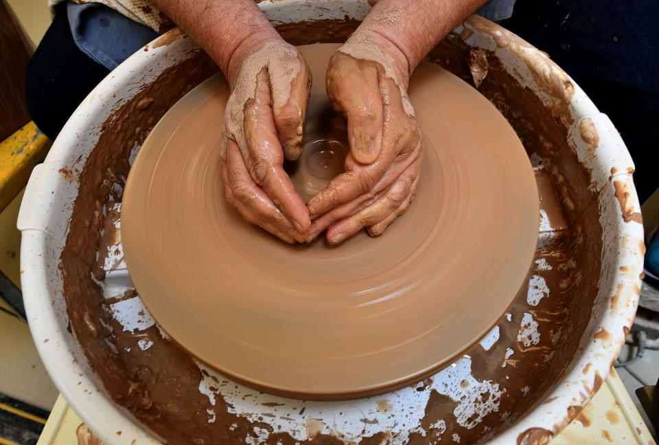 Steve Miller of Northbridge works on small mound of clay during "Introduction to Wheel Throwing" pottery class at the Worcester Center for Crafts on Sagamore Road last week.