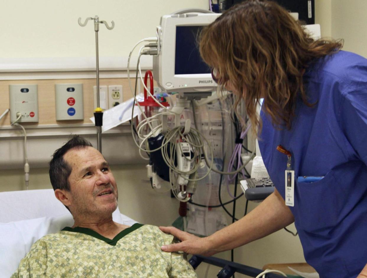 In this Dec. 3, 2014 photo, liver cancer patient Crispin Lopez Serrano talks to an oncology nurse at a hospital in Clackamas, Ore. <a href="http://www.apimages.com/metadata/Index/Health-Overhaul-Palliative-Care/2239f6ec8a9d48328b642042787d1adc/32/0" rel="nofollow noopener" target="_blank" data-ylk="slk:AP Photo/Gosia Wozniacka;elm:context_link;itc:0;sec:content-canvas" class="link ">AP Photo/Gosia Wozniacka</a>