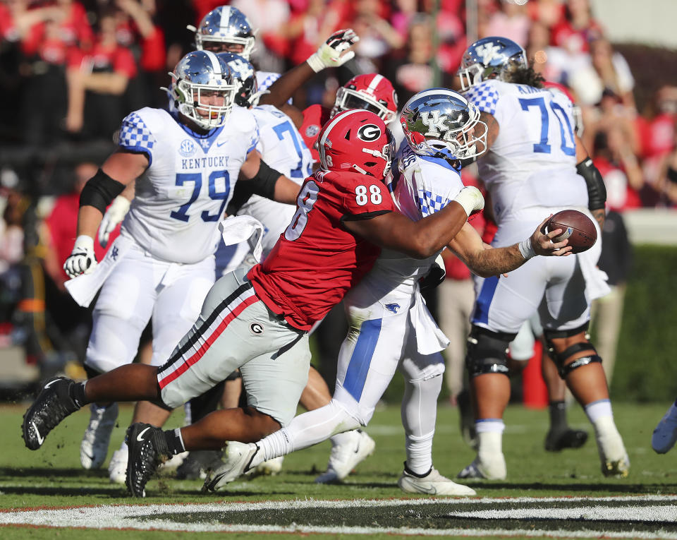 Georgia defensive lineman Jalen Carter strip sacks Kentucky quarterback Will Levis with Georgia recovering during the second quarter but the play was called back and ruled an incomplete pass after review in a NCAA college football game on Saturday, Oct. 16, 2021, in Athens. (Curtis Compton/Atlanta Journal-Constitution via AP)