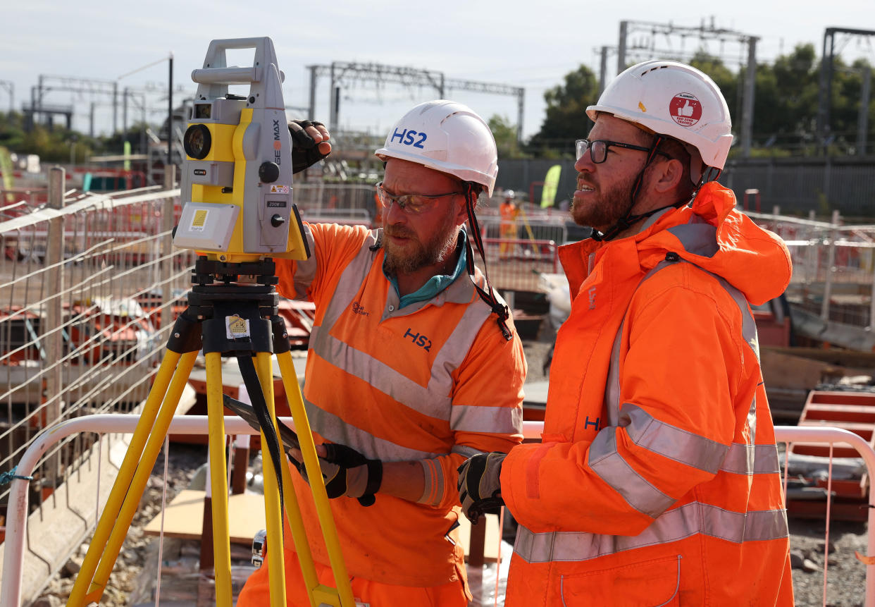 UK construction workers operate a piece of measuring equipment at the HS2 rail Curzon Street Station