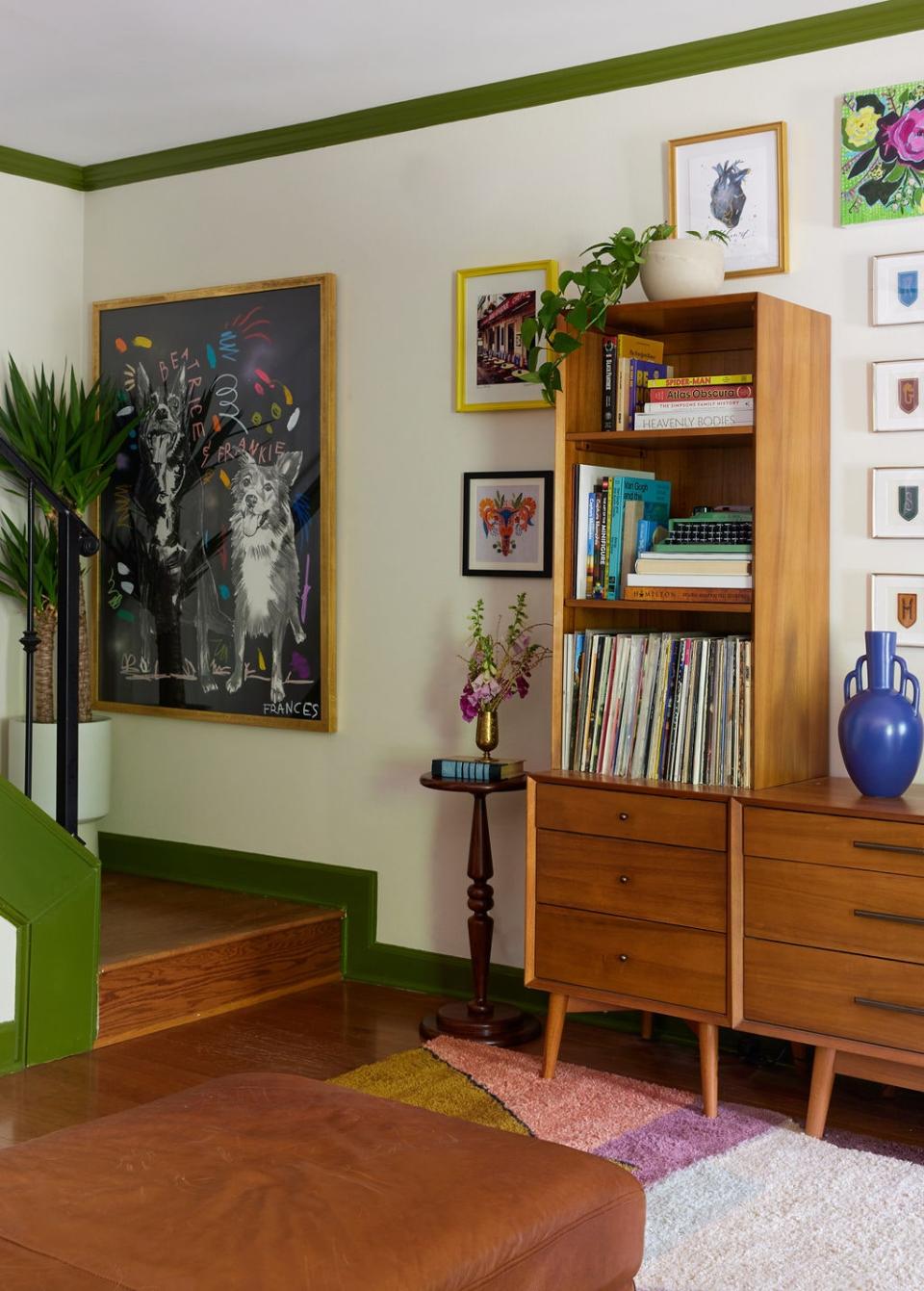 A delicate wooden cocktail table from HomeGoods serves as a bookend to the console. By the landing hangs a life-size painting, an ode to the owner’s late dog Beatrice, by Frances Berry Moreno.