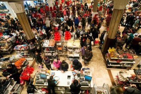 FILE PHOTO: Shoppers look over items on sale at a Macy's store in New York, NY, U.S. on November 23, 2012. REUTERS/Keith Bedford/File Photo