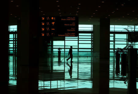 A worker cleans the floor of the newly built Islamabad International Airport, during a media tour ahead of its official opening, Pakistan April 18, 2018. REUTERS/Faisal Mahmood