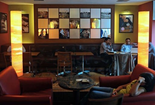 Customers sit at a Coffee Bean and Tea Leaf outlet in Mumbai in July 2012. Starbucks is betting on big returns as it seeks to lure an expanding legion of coffee lovers in India -- primarily a tea-drinking nation where lifestyle changes have spawned a booming market for cafes