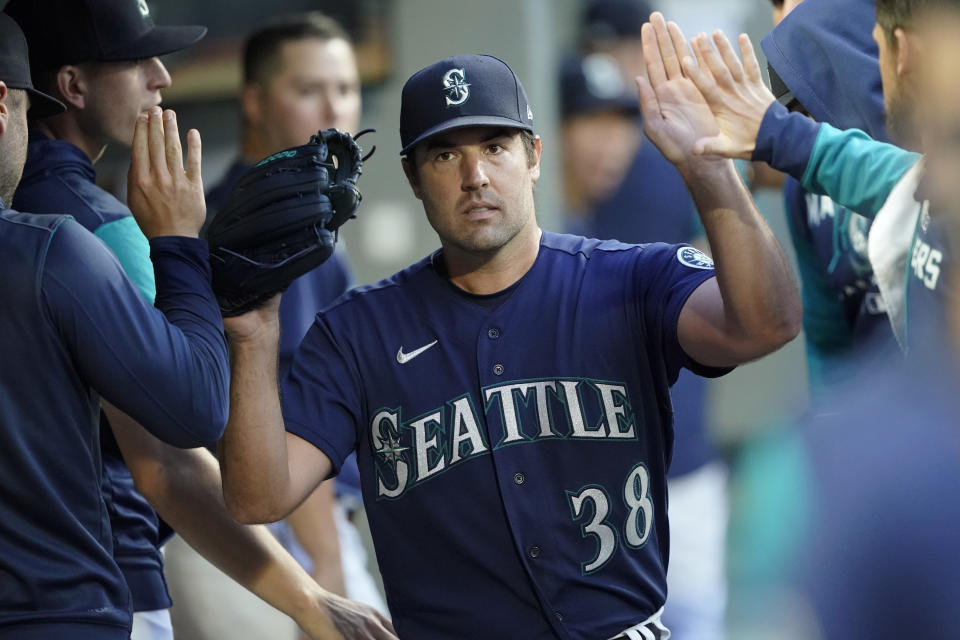 Seattle Mariners starting pitcher Robbie Ray is greeted in the dugout after getting out of a based-loaded jam in the fifth inning of the team's baseball game against the Toronto Blue Jays, Saturday, July 9, 2022, in Seattle. (AP Photo/Ted S. Warren)