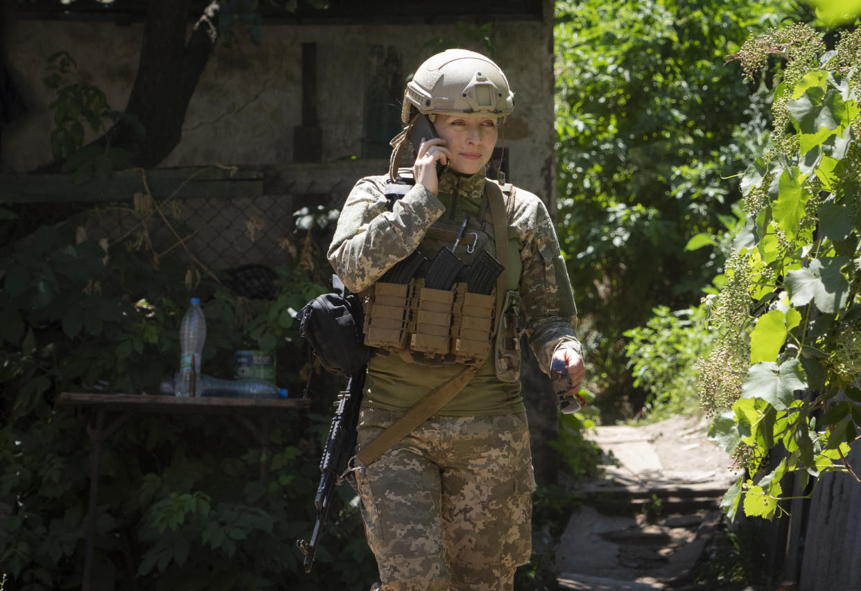 Ukrainian platoon commander Mariia talks on the phone in a position in the Donetsk region, Ukraine, Saturday, July 2, 2022. (AP Photo/Efrem Lukatsky)