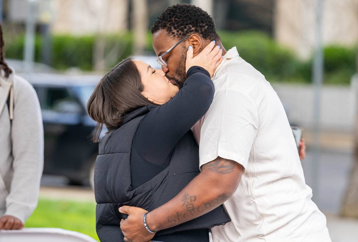 Jovontue Dorsett, 36, and Shelby Ray, 31, kiss after getting engaged at the World Peace Rose Garden in Sacramento’s Capitol Park on Sunday, March 3, 2024. Cameron Clark/cclark@sacbee.com