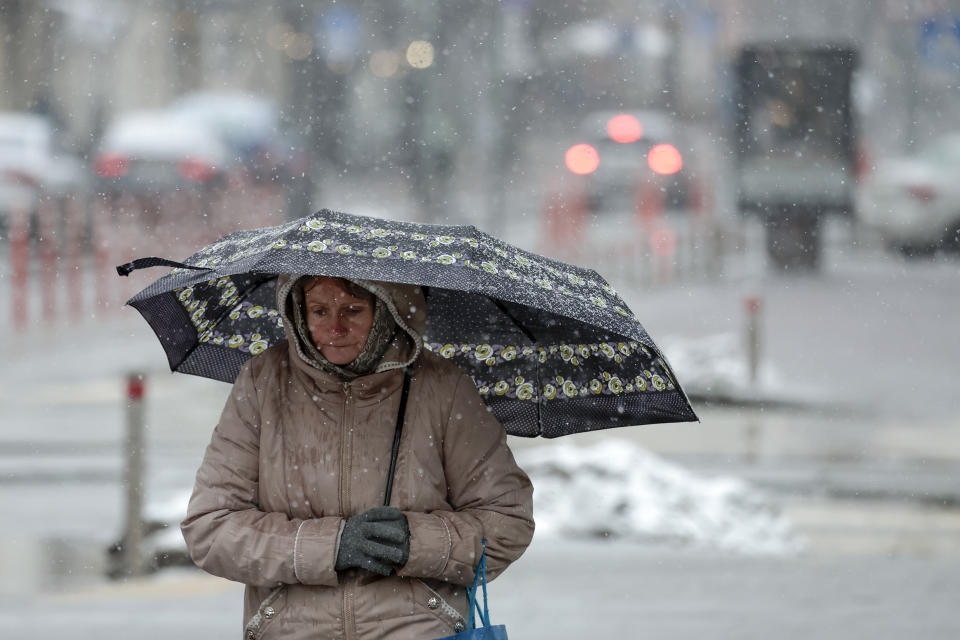 A woman is seen making her way through the snow on Nov. 27 in Kyiv. 