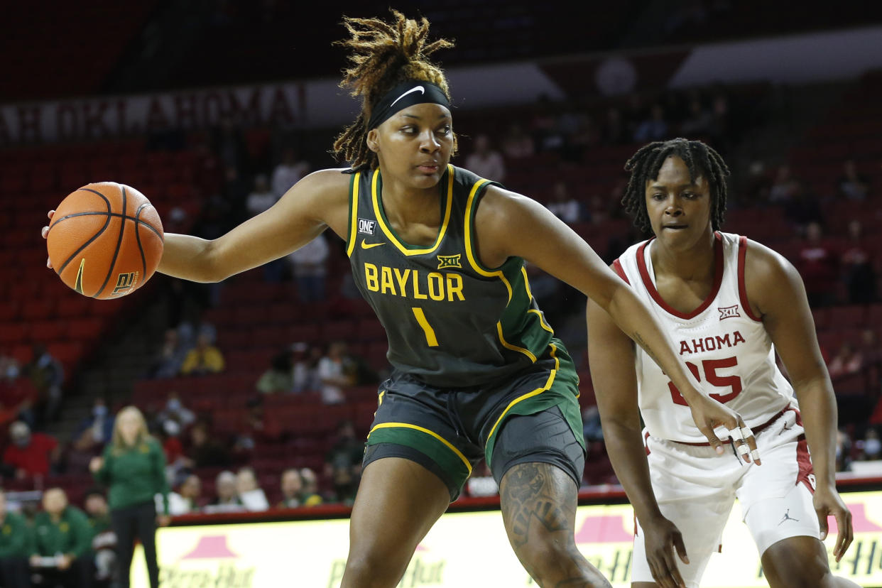 Baylor forward NaLyssa Smith goes to the basket, guarded by Oklahoma guard Madi Williams during their women's college basketball game.