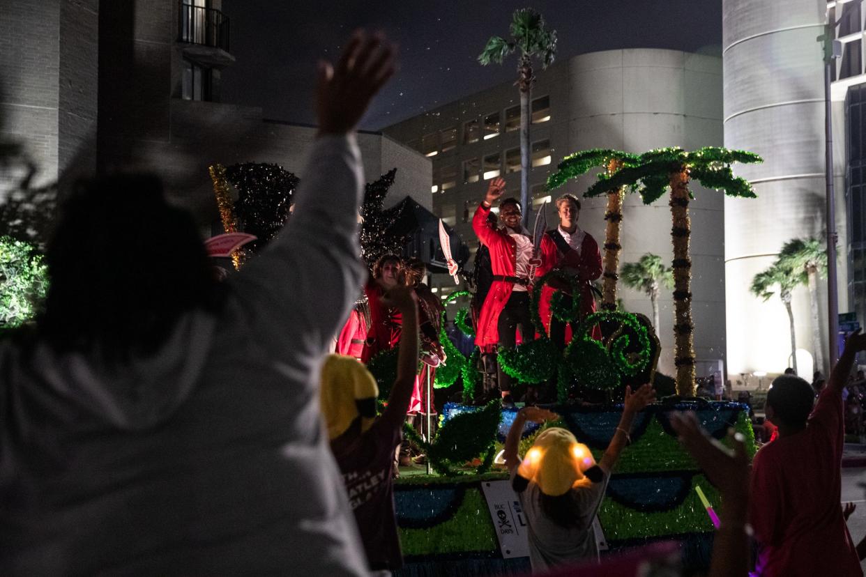 A crowd waves at a passing Port of Corpus Christi float during the annual Buc Days Night Parade on Saturday, May 6, 2023, in Corpus Christi, Texas.