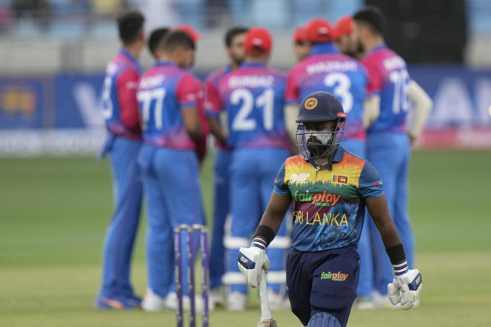 Sri Lanka's Charith Asalanka reacts while he walks back to pavilion after his dismissal during the T20 cricket match of Asia Cup between Afghanistan and Sri Lanka, in Dubai, United Arab Emirates, Saturday, Aug. 27, 2022. (AP Photo/Anjum Naveed)