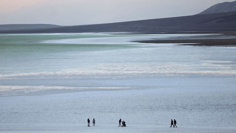  People visiting a lake at Death Valley. 