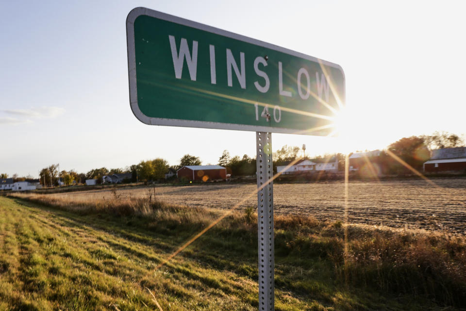 In this Oct. 24, 2019 photo, the sun sets over Winslow, Neb. It took only minutes for swift-moving floods from the Elkhorn River to ravage tiny Winslow this spring, leaving nearly all its 48 homes and businesses uninhabitable. Now, the couple dozen residents still determined to call the place home are facing a new challenge: Moving the entire town several miles away to higher ground. (AP Photo/Nati Harnik)