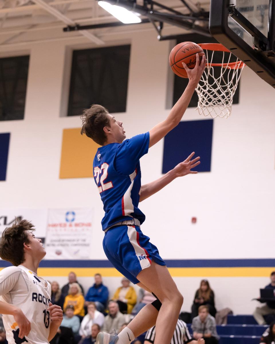 Ravenna senior forward Mason Ross puts in a lay-up during Tuesday night’s basketball game at Streetsboro High School.