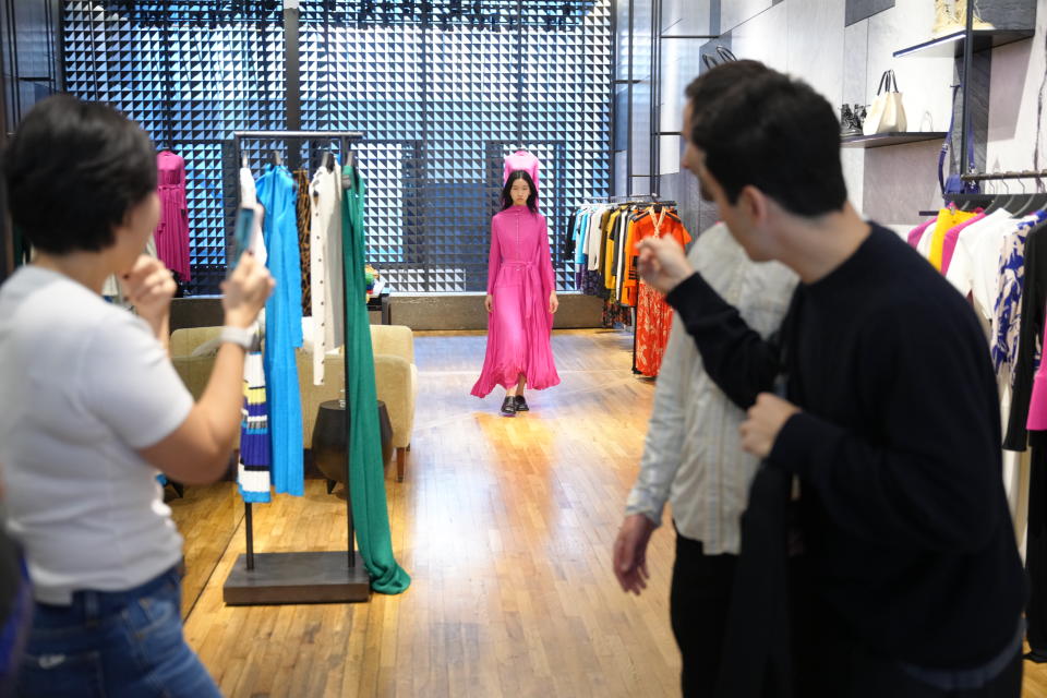 Jack McCollough and Lazaro Hernandez showcasing a look to host Zoe Zhang during the Proenza Schouler Tmall livestream. - Credit: Courtesy of Alibaba
