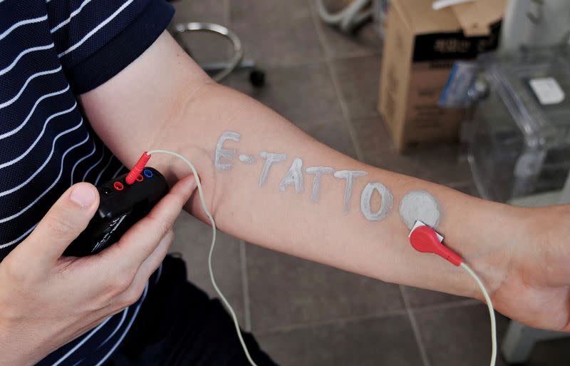 Steve Park, Materials Science & Engineering professor at Korea Advanced Institute of Science and Technology (KAIST), demonstrates an electronic tattoo (e-tattoo) on his arm connected with an electrocardiogram (ECG) monitoring system in Daejeon