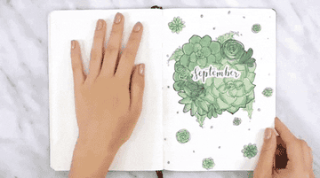 a person flipping through a bullet journal