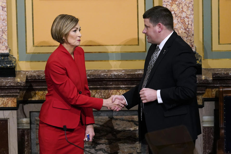 FILE- In this Jan. 12, 2021, file photo Iowa Gov. Kim Reynolds greets Iowa House Speaker Pat Grassley, right, after delivering her Condition of the State address before a joint session of the Iowa Legislature at the Statehouse in Des Moines, Iowa. Iowa Democrats are beginning to consider changes to their get-out-the-vote plans under the assumption that Reynolds will sign into law a Republican-backed bill that makes it harder to vote early, potentially eroding a key aspect of Democratic campaigns. (AP Photo/Charlie Neibergall, File)