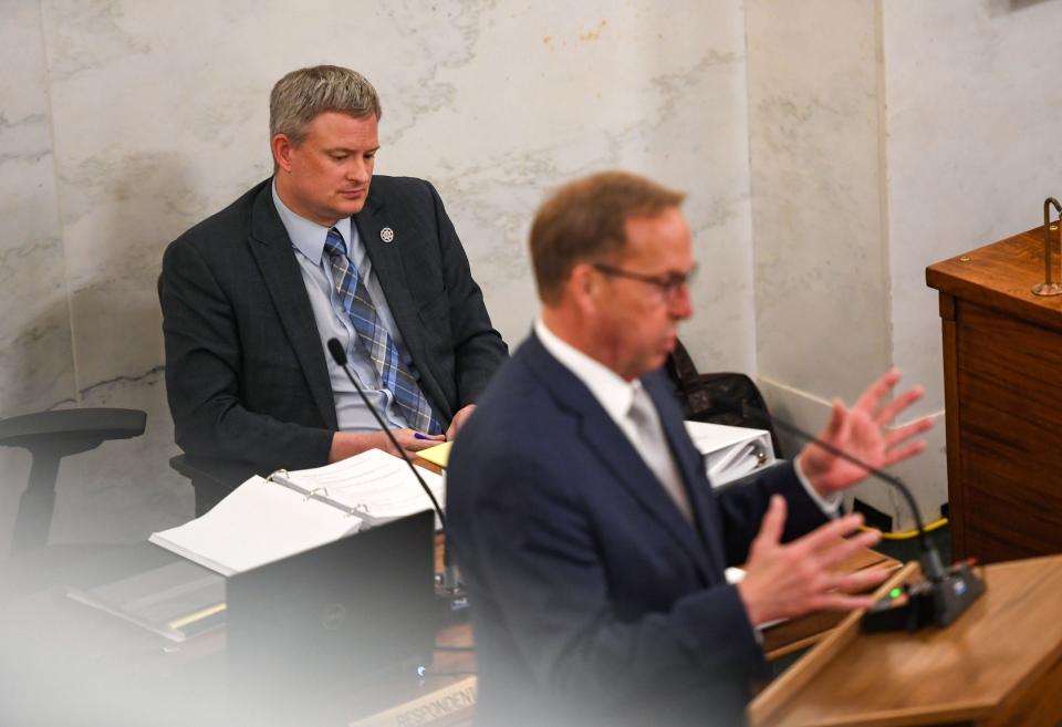 Attorney General Jason Ravnsborg looks down while his attorney, Mike Butler, responds to a senator's question at the dais during the impeachment trial of Ravnsborg on Tuesday, June 21, 2022, at the South Dakota State Capitol in Pierre.