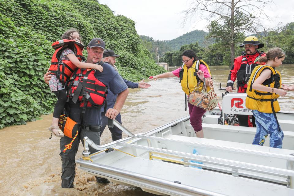 A group of stranded people are rescued from the floodwaters in Jackson, Ky., on Thursday. 