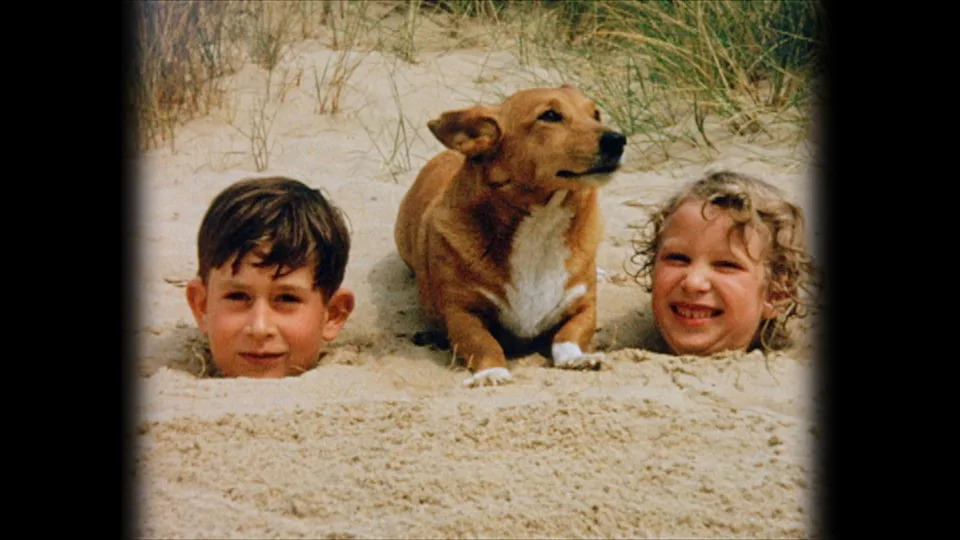 Embargoed to 2200 Thursday May 31. British Pathe handout photo dated 1957 of the Prince of Wales (left) and Princess Royal (right) as children with a corgi on Holkham Beach, Norfolk , which features in the heir to the throne's personal television tribute to his mother the Queen which draws on archive news reels and never before seen royal films and photographs.