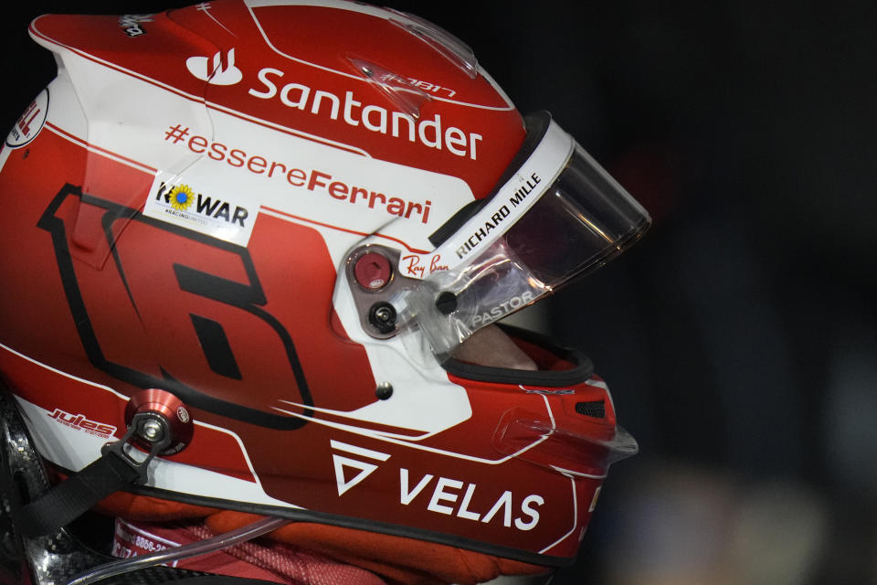 A sign, No war, is placed on helmet of Ferrari driver Charles Leclerc of Monaco in support of Ukraine as he celebrates the Bahrain Formula One Grand Prix at the Formula One Bahrain International Circuit in Sakhir, Bahrain, Sunday, March 20, 2022. (AP Photo/Hassan Ammar)