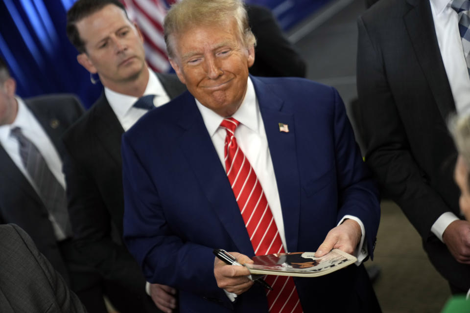 Republican presidential candidate former President Donald Trump signs autographs after speaking at a rally at Des Moines Area Community College in Newton, Iowa, Saturday, Jan. 6, 2024. (AP Photo/Andrew Harnik)