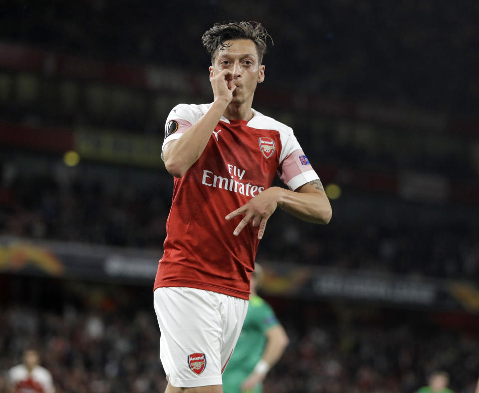 Arsenal's Mesut Ozil celebrates after he scored his side's 4th goal during the Europa League Group E soccer match between Arsenal and Vorskla in London, England, Thursday, Sept. 20, 2018. (AP Photo/Kirsty Wigglesworth)