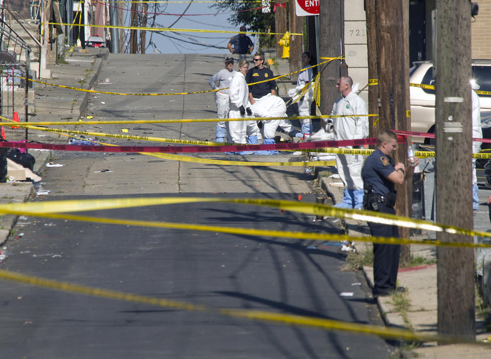 Police join members of the ATF and the FBI as they investigate North Hall Street in Allentown, Pa., Sunday, Sept. 30, 2018, after a fiery car explosion rocked the neighborhood on Saturday. Police confirmed at least one fatality and at least 50 investigators remain on the scene scouring for evidence. (Harry Fisher/The Morning Call via AP)