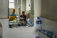 Tekien Tadese, 25, holds her baby, Amanuel Mulu, 22 months old, who is suffering from malnutrition and weighs only 6.7 kilograms (14 pounds and 12 ounces), at the Ayder Referral Hospital in Mekele, in the Tigray region of northern Ethiopia, on Monday, May 10, 2021. The child was unconscious when he was first admitted in April, severely malnourished and anemic after losing half his body weight. Two weeks in intensive care saved his life. (AP Photo/Ben Curtis)