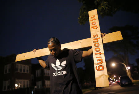 A protestor takes part in a weekly night-time peace march through the streets of a South Side neighborhood organized by Father Michael Pfleger in Chicago, Illinois, September 16, 2016. REUTERS/Jim Young