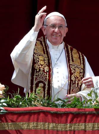 FILE PHOTO: Pope Francis waves during his "Urbi et Orbi" (to the city and the world) message from the balcony overlooking St. Peter's Square at the Vatican on April 16, 2017. REUTERS/Stefano Rellandini/File Photo