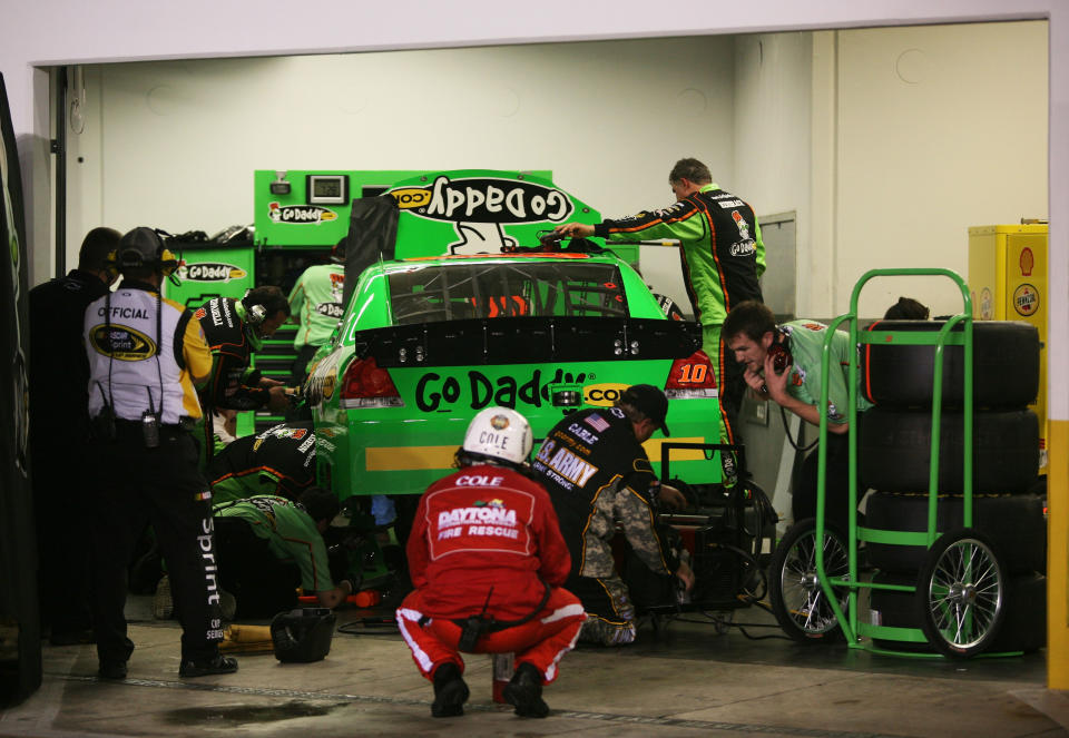 DAYTONA BEACH, FL - FEBRUARY 27: Crew members work on the #10 GoDaddy.com Chevrolet driven by Danica Patrick in the garage after being involved in an on track incident during the NASCAR Sprint Cup Series Daytona 500 at Daytona International Speedway on February 27, 2012 in Daytona Beach, Florida. (Photo by Jerry Markland/Getty Images for NASCAR)