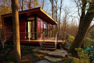 <p>Set in a wooded area, this 300-square-foot studio retreat in Chappaqua, New York, is nestled between two rock outcroppings—one is used as a backdrop and the other as a bookend to the deck. The design team at <a href="http://www.workshopapd.com/" rel="nofollow noopener" target="_blank" data-ylk="slk:Workshop/APD;elm:context_link;itc:0;sec:content-canvas" class="link ">Workshop/APD</a> chose Dark Ipe siding and decking and walnut interiors for a natural mid-century modern look that connects the structure to its wooded surroundings. Windows wrapping the western facade frame the scenery and visually enlarge the intimate space.</p><p><a class="link " href="http://www.workshopapd.com/portfolio/residential/studio-retreat" rel="nofollow noopener" target="_blank" data-ylk="slk:SEE INSIDE;elm:context_link;itc:0;sec:content-canvas">SEE INSIDE</a></p>