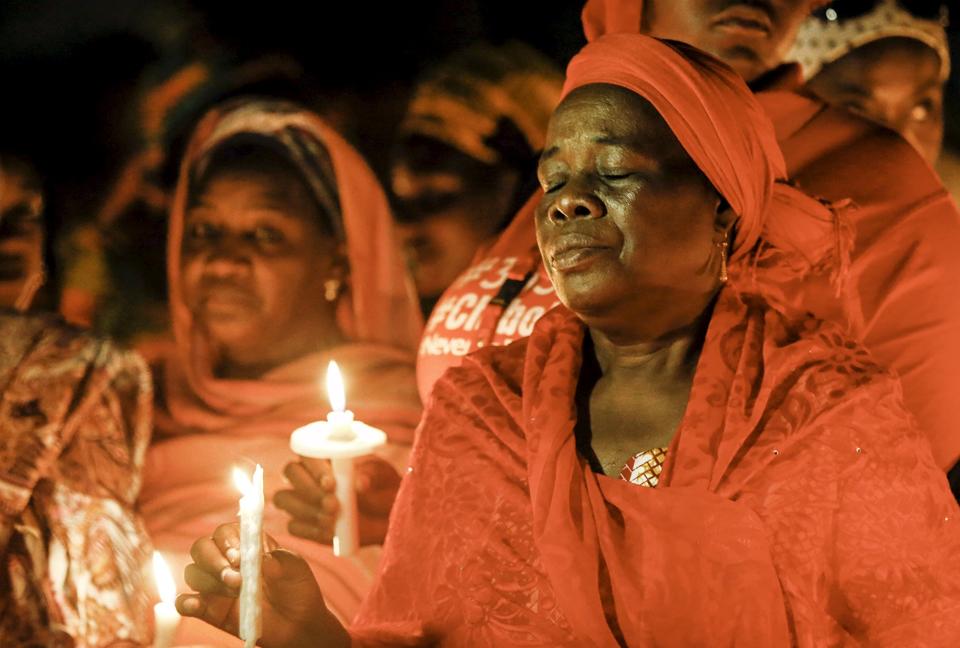 People hold candles during a vigil for the girls who were abducted from a secondary school in Chibok, on the anniversary of their abduction. Nigeria's President-elect Muhammadu Buhari vowed on Tuesday to make every effort to free more than 200 schoolgirls abducted by Boko Haram militants a year ago but admitted it was not clear whether they would ever be found. (REUTERS/Afolabi Sotunde)