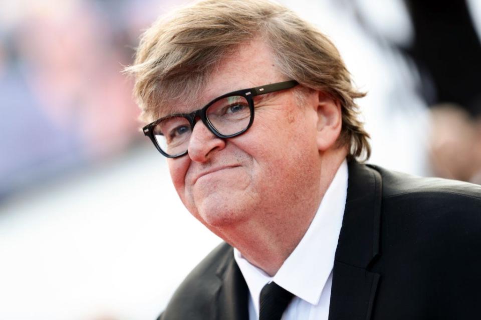 Michael Moore smiles at an event.