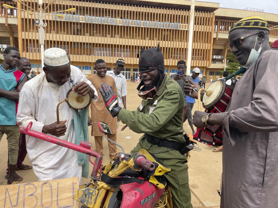 Supporters of Niger's ruling junta play instruments in Niamey, Niger, Sunday, Aug. 6, 2023. Nigeriens are bracing for a possible military intervention as time's run out for its new junta leaders to reinstate the country's ousted president. (AP Photo/Sam Mednick)