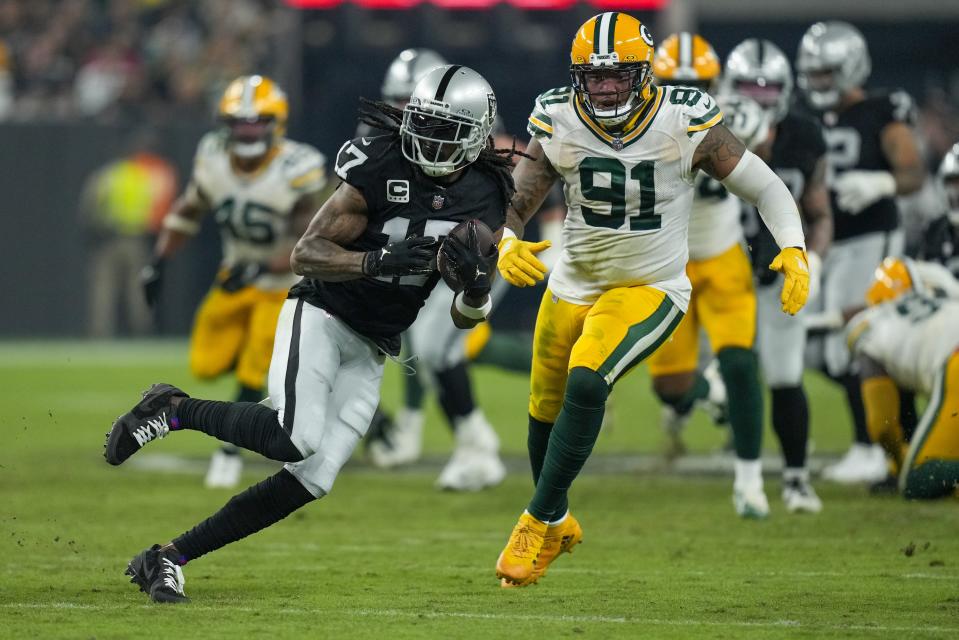 Las Vegas Raiders' Davante Adams catches a pass in front of Green Bay Packers' Preston Smith during the second half of an NFL football game Monday, Oct. 9, 2023, in Las Vegas. (AP Photo/John Locher)