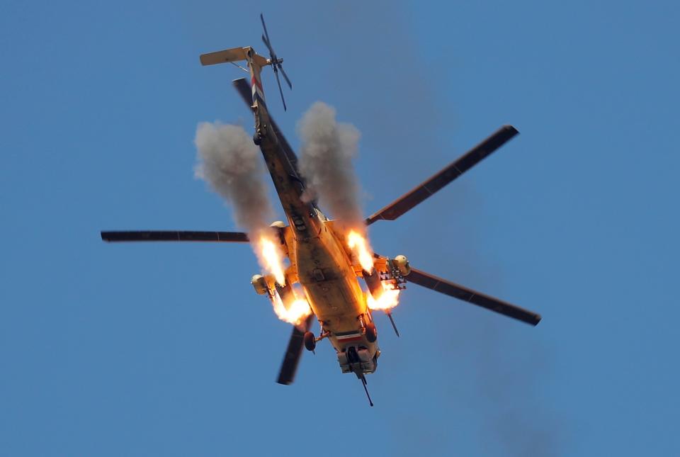 <p>An Iraqi Airforce helicopter fires missiles at Islamic State fighters at the outskirts of Mosul, Iraq, February 26, 2017. (Goran Tomasevic/Reuters) </p>