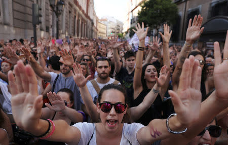 Protesters attend a demonstration against the release on bail of five men known as the "Wolf Pack" cleared of gang rape of a teenager and convicted of a lesser crime of sexual abuse in Madrid, Spain, June 22, 2018. REUTERS/Susana Vera