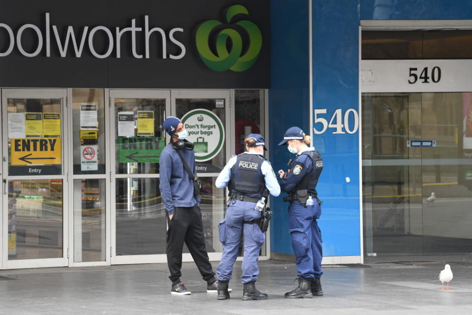 Police officers checking people and their purpose of movement into the CBD in Sydney, Australia. 