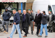 Palestinian geographer Khalil Tafakji (C), who runs a Palestinian map office, is detained by Israeli security officers as they carry out an Israeli police order to close the office, in the Arab East Jerusalem neighbourhood of Beit Hanina March 14, 2017. REUTERS/Ammar Awad