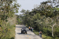 Migrants trek on the highway from Frontera Corozal to Palenque, Chiapas state, Mexico, Wednesday, March 24, 2021. (AP Photo/Eduardo Verdugo)