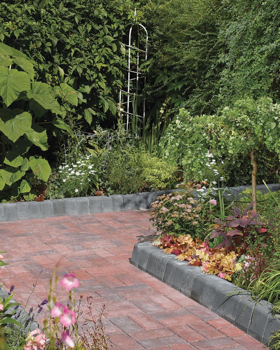<p> Give your driveway a boost by adding a curb. Not only will it look stylish, but it will also protect your treasured flower beds from being accidentally driven over. </p> <p> Of course, this approach is not only reserved for driveways. You could use curb stones to define your garden paths, too. Opt for a dark charcoal shade for a modern, fuss-free look. It works well with many types of paving, but we love how it offsets this red brick design.&#xA0; </p>