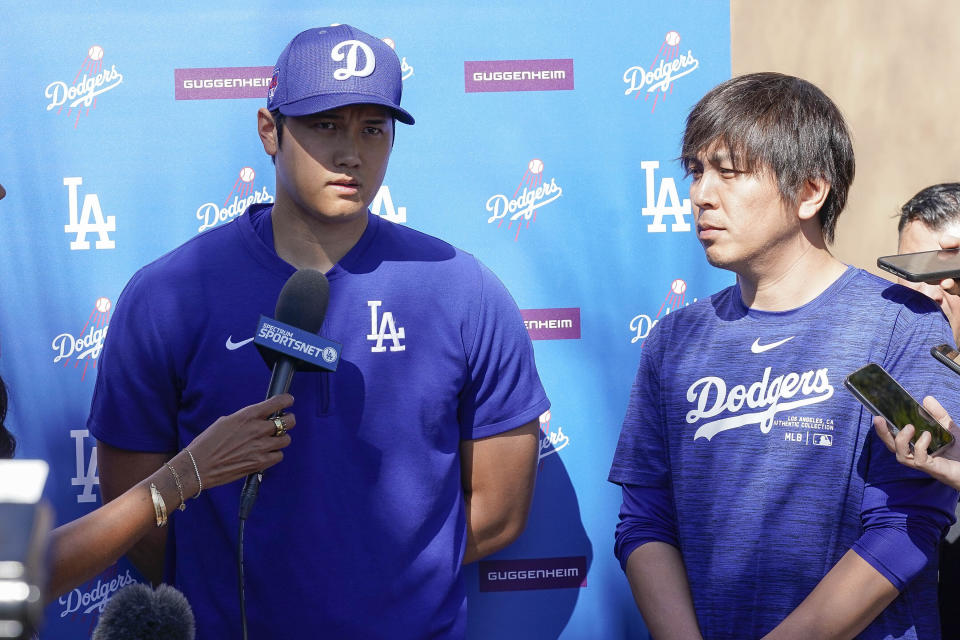 Los Angeles Dodgers designated hitter Shohei Ohtani, left, and his translator Ippei Mizuhara, right, addresses the media about Ohtani's surprise marriage announcement, Thursday, Feb. 29, 2024, during spring training baseball workouts at Camelback Ranch in Phoenix. (AP Photo/Darryl Webb)