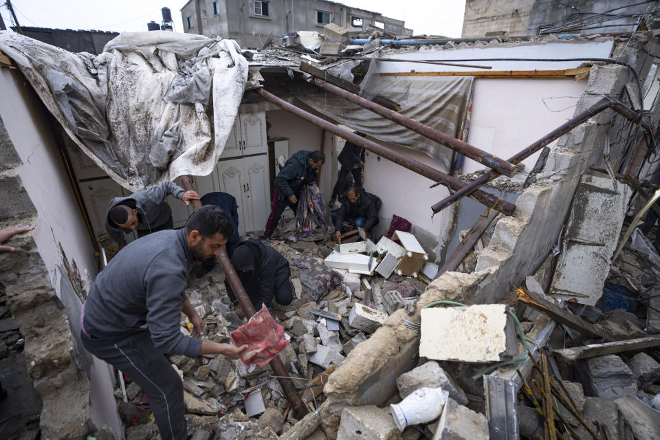 Palestinians inspect the damage to a house after an Israeli airstrike in Rafah, southern Gaza Strip, Tuesday, March 19, 2024. (AP Photo/Fatima Shbair)