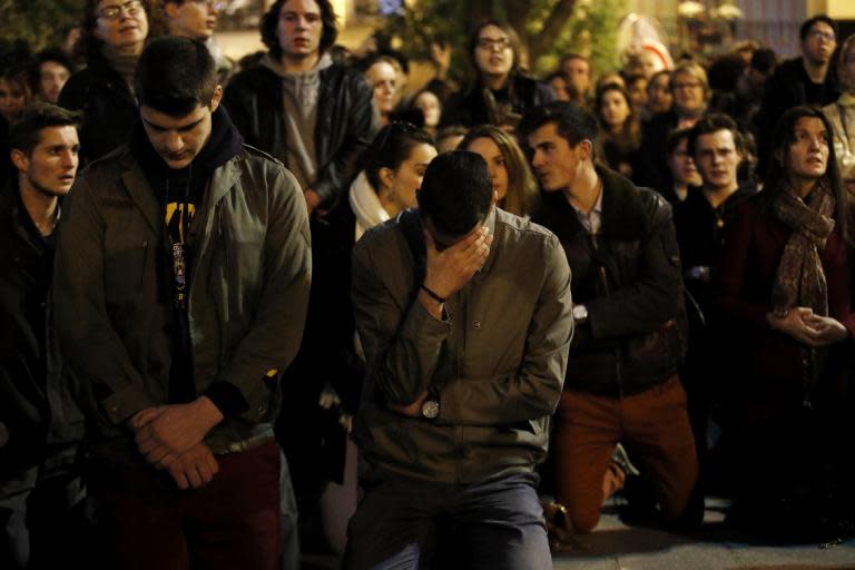 Notre Dame cathedral fire: Parisians pray, sing and watch in horror as landmark falls