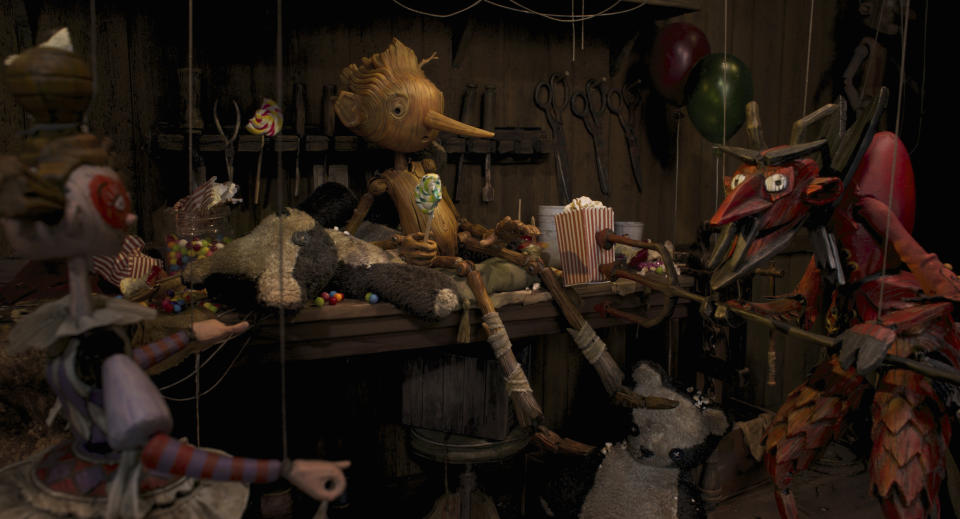This image released by Netflix shows Pinocchio, voiced by Gregory Mann, center, in a scene from "Guillermo del Toro's Pinocchio." (Netflix via AP)